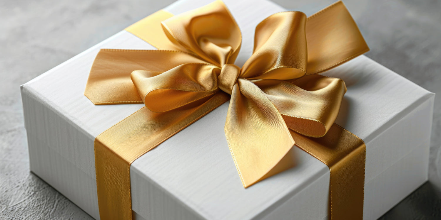 A beautifully wrapped gift box in kraft wrap with a sprig of Christmas foliage